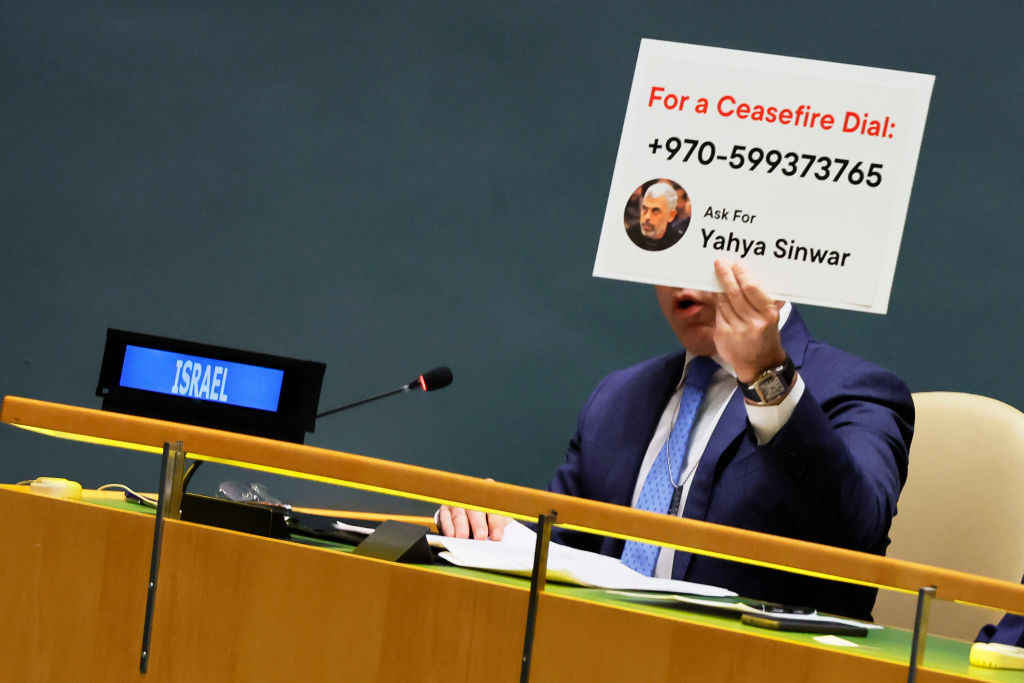 Permanent Representative of Israel to the United Nations Gilad Erdan holds up a sign with the contact information of Hamas leader Yahya Sinwar.