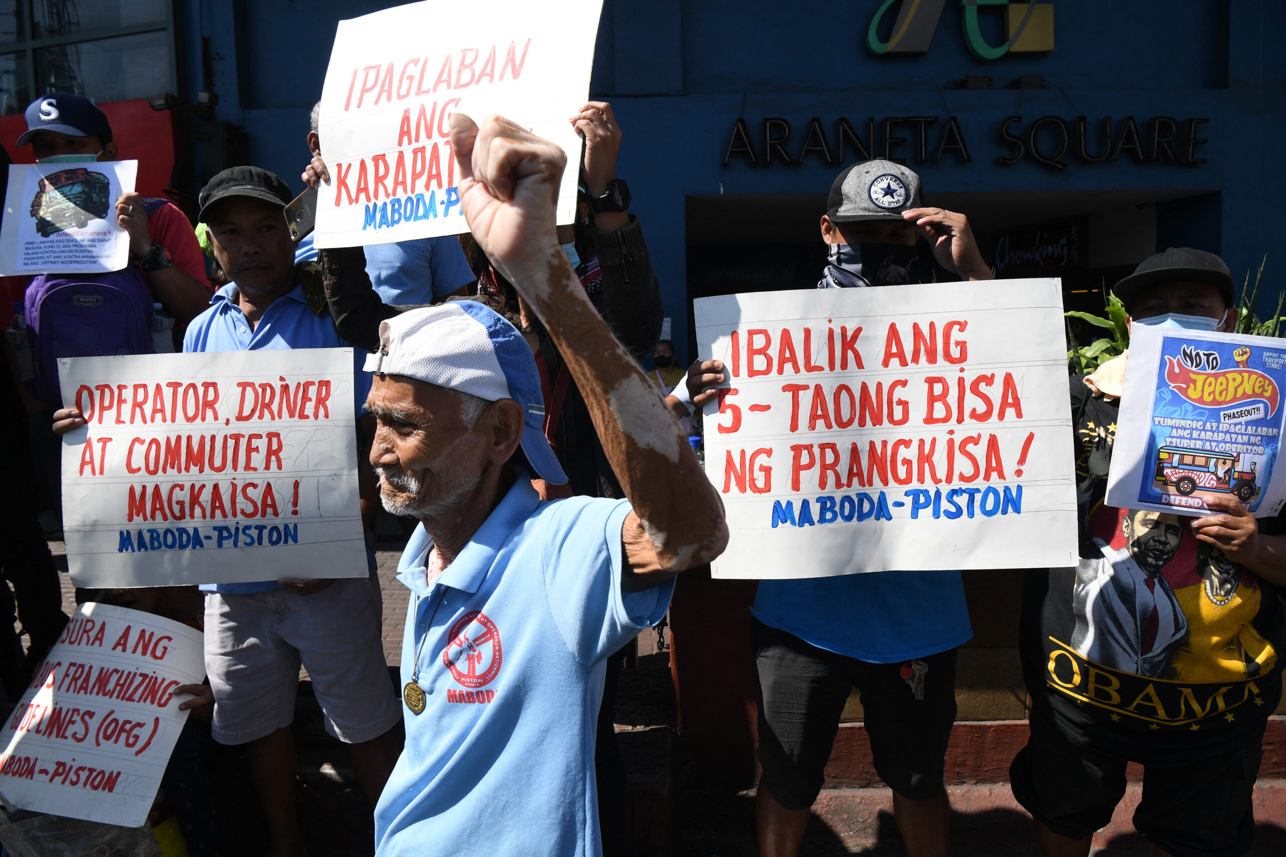 A jeepeney driver raises a clinched fist during a rally to coincide with their transport strike in Caloocan City, suburban Manila on March 6, 2023.