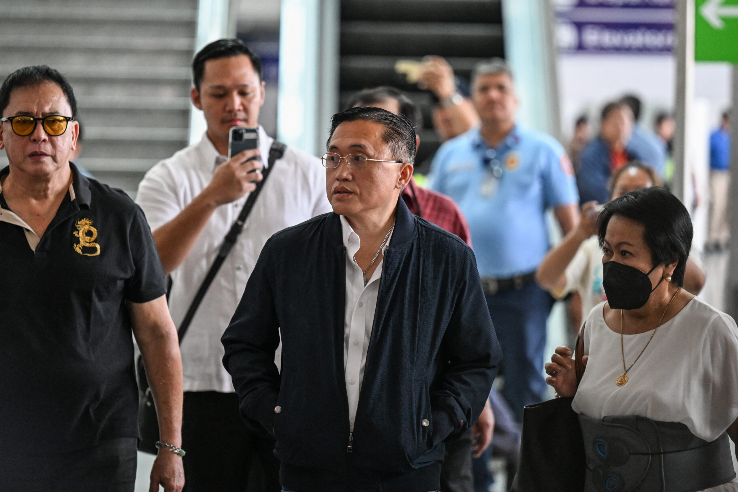 Senator Christopher "Bong" Go (C), an ally of former Philippine president Rodrigo Duterte, faces the media as they wait for the arrival of Duterte at Ninoy Aquino International Airport in Pasay, metro Manila on March 11, 2025.