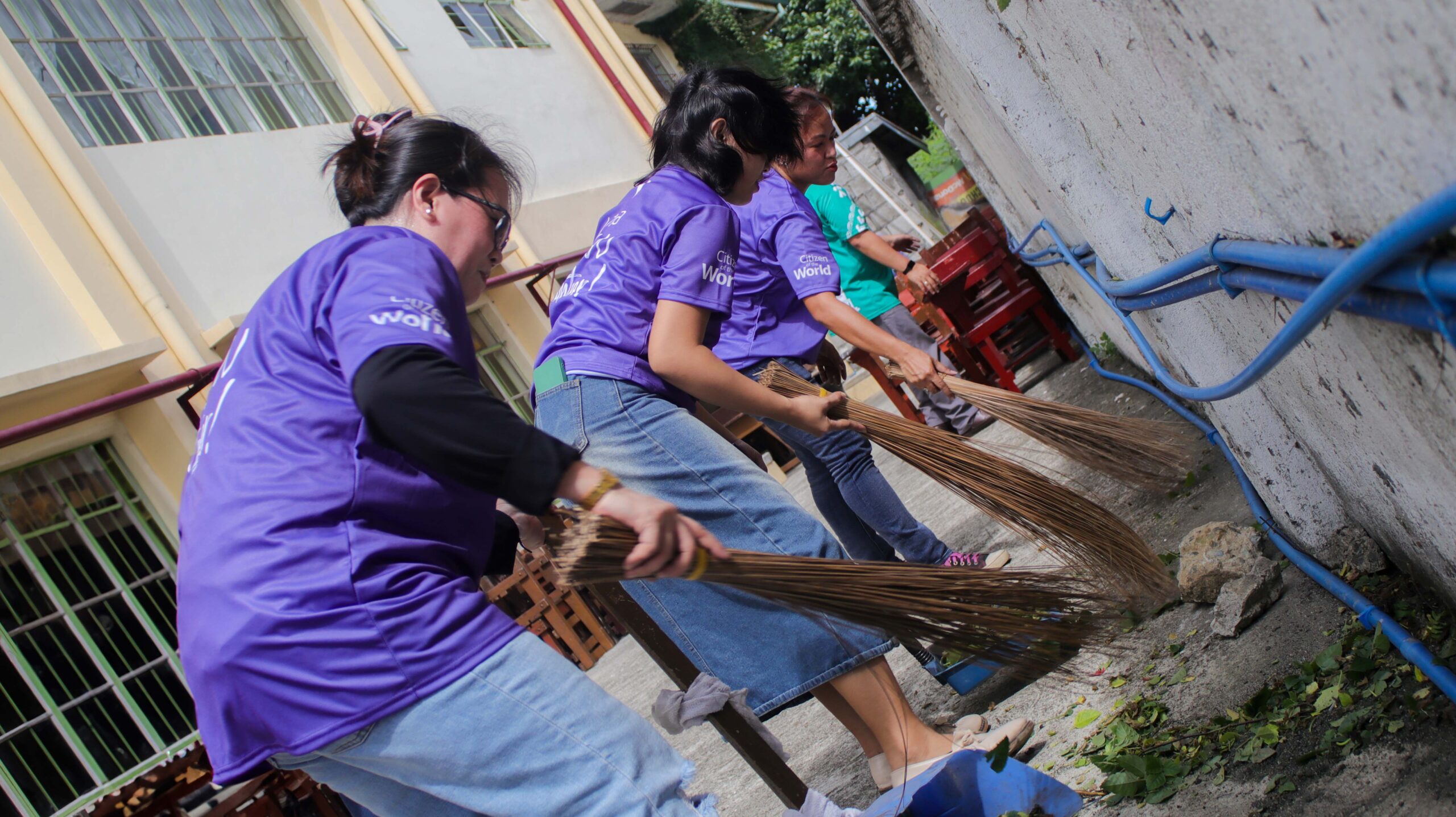 TP Dreambuilder volunteers cleaning the Molino Elementary School grounds in Bacoor City, Cavite.