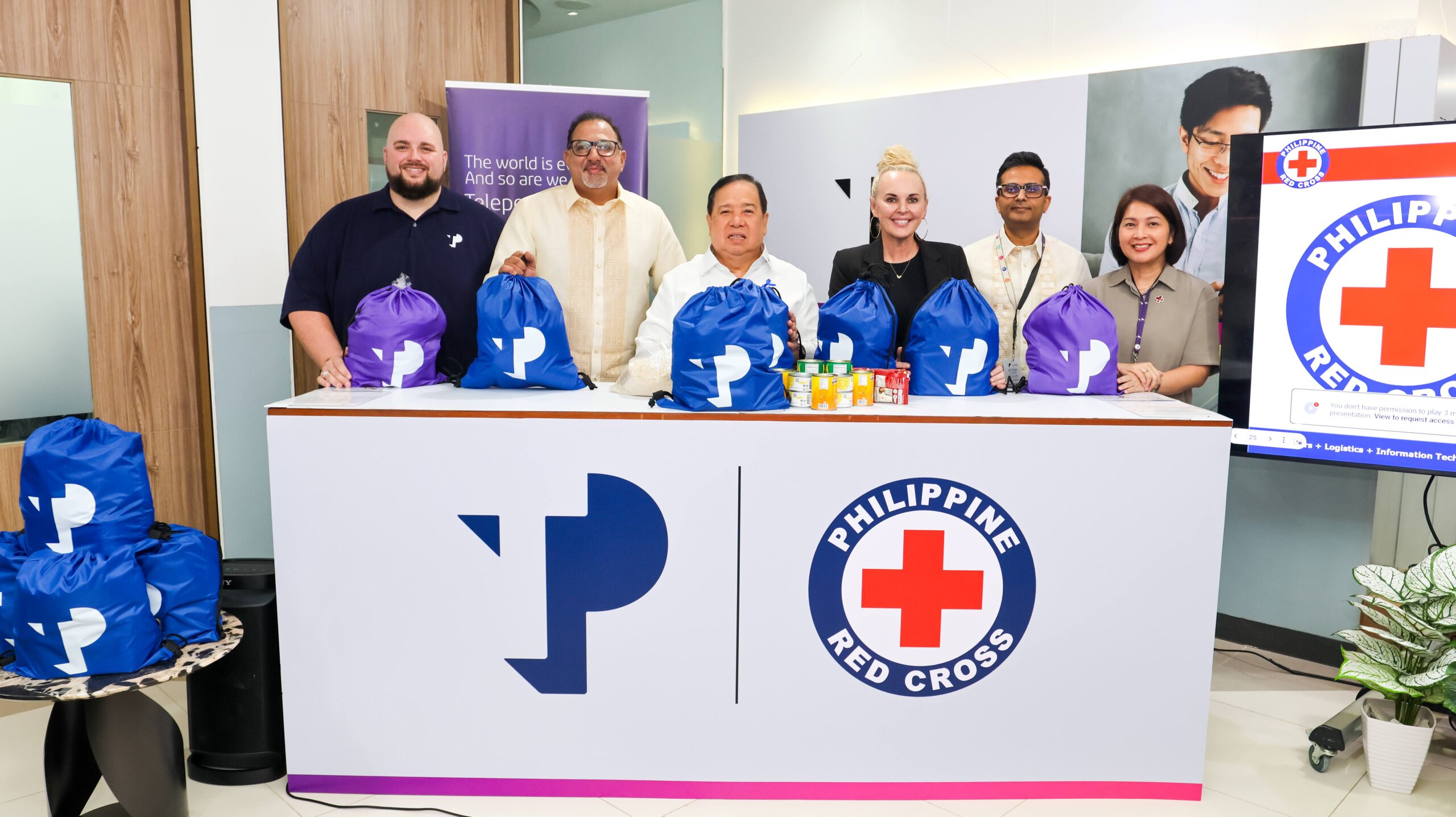 Leaders from TP and the Philippine Red Cross came together for a symbolic packing activity during the TP and Philippine Red Cross Donation Handover Ceremony.